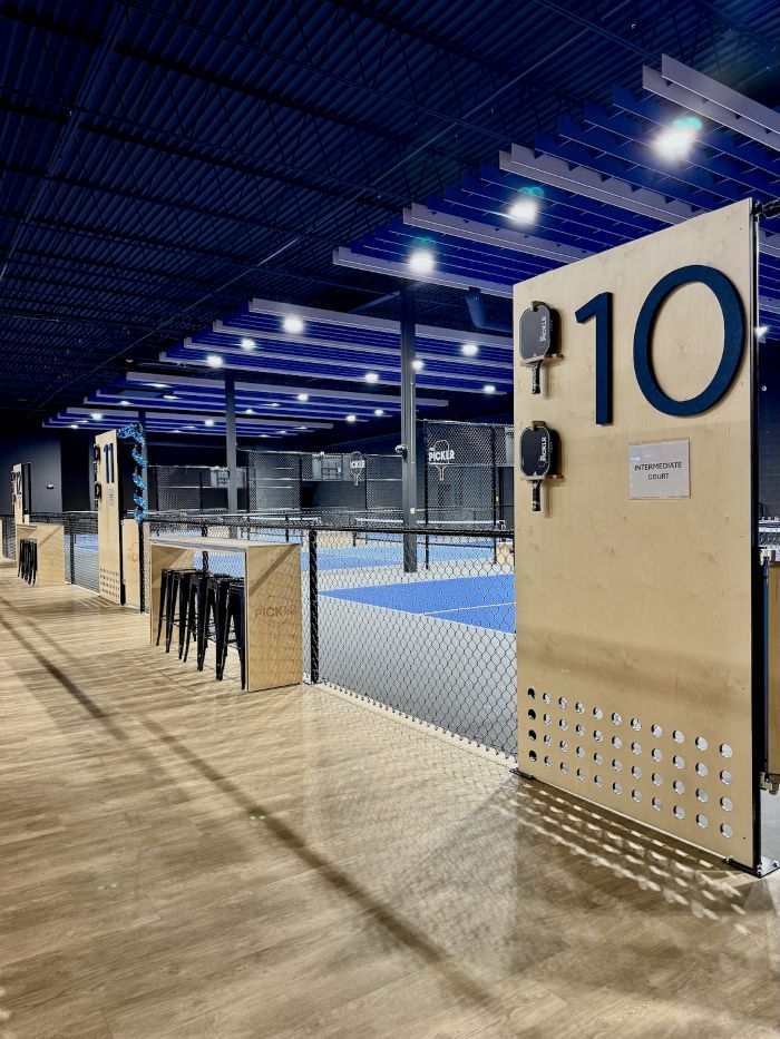 Commercial gym or fitness center with durable speckled flooring and modern branding